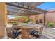 Outdoor kitchen on patio featuring a grill, pizza oven, and dining area at 41624 N Anthem Ridge Dr, Anthem, AZ 85086