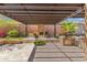 An outdoor oasis, this covered patio includes a fireplace, built-in BBQ, and ample seating at 41624 N Anthem Ridge Dr, Anthem, AZ 85086