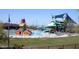 Community pool with slides, splash pads, lounge chairs, and covered seating area at 41624 N Anthem Ridge Dr, Anthem, AZ 85086