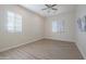 A bright bedroom with two windows and hardwood floors at 4241 N Pebble Creek Pkwy # 54, Goodyear, AZ 85395