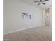 Bright bedroom features wood-look floors, ceiling fan, neutral walls and decor at 4241 N Pebble Creek Pkwy # 54, Goodyear, AZ 85395