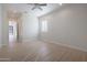 Large bedroom with ample natural light, light wood floors, and a view into the hallway at 4241 N Pebble Creek Pkwy # 54, Goodyear, AZ 85395