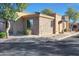 Beautiful home exterior with a stone facade, desert landscaping, and a tile roof at 4241 N Pebble Creek Pkwy # 54, Goodyear, AZ 85395