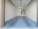 Clean garage features painted floor, utility hook ups, and a white door at 4241 N Pebble Creek Pkwy # 54, Goodyear, AZ 85395