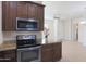 Kitchen boasts stainless steel appliances, granite countertops and view to a dining area at 4241 N Pebble Creek Pkwy # 54, Goodyear, AZ 85395
