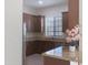 Kitchen boasts brown cabinets, granite countertops, stainless steel appliances and a window view at 4241 N Pebble Creek Pkwy # 54, Goodyear, AZ 85395