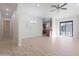 Spacious living area featuring light wood floors, modern lighting, and a sliding door to backyard at 4241 N Pebble Creek Pkwy # 54, Goodyear, AZ 85395
