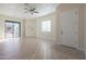 Bright living area features light wood floors, a glass sliding door and a white entry door at 4241 N Pebble Creek Pkwy # 54, Goodyear, AZ 85395
