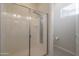 Bathroom featuring a glass-enclosed shower with multiple shower heads and a built-in shelf at 4241 N Pebble Creek Pkwy # 54, Goodyear, AZ 85395