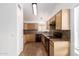 Well-lit kitchen with wood cabinets, black appliances, and mosaic backsplash at 4245 E Jason Dr, Phoenix, AZ 85050