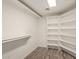 Walk-in closet with custom shelving and updated tile floors provides plenty of storage space at 4536 E Beck Ln, Phoenix, AZ 85032
