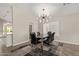 Dining room showcases modern light fixture, seating for six, and tile floors at 4536 E Beck Ln, Phoenix, AZ 85032