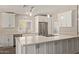 Bright kitchen features white cabinetry, stainless steel appliances, large center island, and updated countertops at 4536 E Beck Ln, Phoenix, AZ 85032