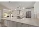 Bright kitchen features white cabinetry, stainless steel appliances, large center island, and views of the backyard at 4536 E Beck Ln, Phoenix, AZ 85032