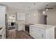 Modern kitchen with white cabinetry, stainless appliances, and sleek countertops overlooking the dining area at 4536 E Beck Ln, Phoenix, AZ 85032