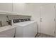 Laundry room featuring white cabinets, a utility sink, and a newer washer and dryer at 4536 E Beck Ln, Phoenix, AZ 85032
