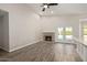 Cozy living room with brick fireplace, wood-look tile flooring, and direct access to the outdoor pool at 4536 E Beck Ln, Phoenix, AZ 85032