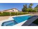 Backyard swimming pool with surrounding patio, hedges, and adjacent hot tub with blue tile at 4536 E Beck Ln, Phoenix, AZ 85032