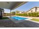 Backyard swimming pool with surrounding patio, hedges, and view of the home's rear facade at 4536 E Beck Ln, Phoenix, AZ 85032