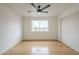 Empty bedroom with hardwood floors, a ceiling fan, a large window, and closet with sliding doors at 4901 S Calle Los Cerros Dr # 236, Tempe, AZ 85282