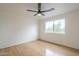 Clean bedroom features wood floors, a ceiling fan, and a window view of the outside at 4901 S Calle Los Cerros Dr # 236, Tempe, AZ 85282