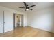 Bedroom features wood floors, a ceiling fan, closet and entrance to the bathroom at 4901 S Calle Los Cerros Dr # 236, Tempe, AZ 85282