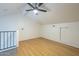 Bright and airy bonus room featuring wood-look floors, ceiling fan, and loft style architecture at 4901 S Calle Los Cerros Dr # 236, Tempe, AZ 85282