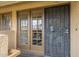 A close-up of a townhome entrance featuring double glass doors with decorative grids and a security door at 4901 S Calle Los Cerros Dr # 236, Tempe, AZ 85282