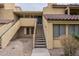 Southwest-style townhome featuring private entrance stairs, tan stucco exterior, and red tile roofing at 4901 S Calle Los Cerros Dr # 236, Tempe, AZ 85282