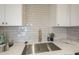 Close-up of the kitchen showcasing the modern stainless steel sink and neutral backsplash at 4901 S Calle Los Cerros Dr # 236, Tempe, AZ 85282