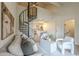 Stylish living room showcasing a unique spiral staircase, neutral color palette, and a glimpse into the kitchen at 4901 S Calle Los Cerros Dr # 236, Tempe, AZ 85282