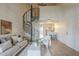 Bright living room with a spiral staircase, modern furniture, and an open layout that flows into the kitchen at 4901 S Calle Los Cerros Dr # 236, Tempe, AZ 85282