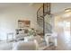 Stylish living room featuring a unique spiral staircase, neutral color palette, and modern design elements at 4901 S Calle Los Cerros Dr # 236, Tempe, AZ 85282