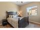 Comfortable bedroom with modern design elements, a full-sized bed, and an abundance of natural light from a nearby window at 4919 E Morning Vista Ln, Cave Creek, AZ 85331