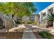 Condo courtyard featuring an elegant fountain, mature trees, and inviting staircases at 5209 N 24Th St # 104, Phoenix, AZ 85016