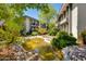 Beautiful courtyard with pond and lush greenery between condo buildings on a sunny day at 5209 N 24Th St # 104, Phoenix, AZ 85016