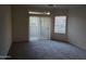 Open living room with neutral paint and plush carpet with large glass sliding door to an outdoor space at 5335 E Shea Blvd # 1035, Scottsdale, AZ 85254