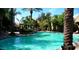 Community pool surrounded by lush landscaping and palm trees, creating a relaxing oasis at 5335 E Shea Blvd # 1035, Scottsdale, AZ 85254