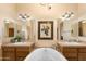 Well-lit bathroom with a jacuzzi tub, double sinks, and framed decor at 5370 S Desert Dawn Dr # 50, Gold Canyon, AZ 85118