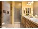 Well-lit bathroom features double sinks, tiled floors, a shower, and modern fixtures at 5370 S Desert Dawn Dr # 50, Gold Canyon, AZ 85118
