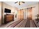 Comfortable bedroom featuring wooden dresser, TV, and sliding barn doors at 5370 S Desert Dawn Dr # 50, Gold Canyon, AZ 85118