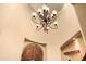 Elegant entryway featuring decorative light fixtures, a rustic wood door, and unique wall decor at 5370 S Desert Dawn Dr # 50, Gold Canyon, AZ 85118