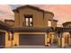 Mediterranean-style home featuring a three-car garage, gated entry and lush greenery at 5370 S Desert Dawn Dr # 50, Gold Canyon, AZ 85118