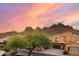 Charming Tuscan-style home featuring desert landscaping and views of the surrounding mountains at sunset at 5370 S Desert Dawn Dr # 50, Gold Canyon, AZ 85118