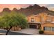 Beautiful desert home featuring a tile roof, stucco walls, multiple garages, and desert landscaping with mountain views at 5370 S Desert Dawn Dr # 50, Gold Canyon, AZ 85118