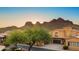 Community home with a well maintained lawn, two car garage, and mountain views at 5370 S Desert Dawn Dr # 50, Gold Canyon, AZ 85118