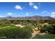 Picturesque view of a vibrant golf course with majestic mountain scenery at 5370 S Desert Dawn Dr # 50, Gold Canyon, AZ 85118