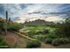 Scenic view of the lush golf course with picturesque mountain backdrop at 5370 S Desert Dawn Dr # 50, Gold Canyon, AZ 85118