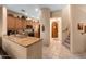 Modern kitchen flows into the hallway, featuring granite countertops and stainless steel appliances at 5370 S Desert Dawn Dr # 50, Gold Canyon, AZ 85118
