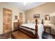 This bedroom offers wood flooring and doors, a ceiling fan, and neutral walls at 5370 S Desert Dawn Dr # 50, Gold Canyon, AZ 85118